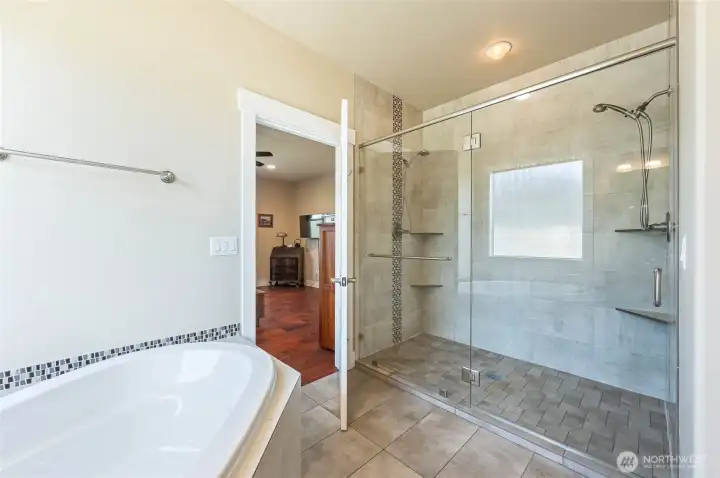 Spacious spa tub near Double headed shower