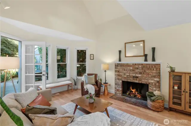 Cozy up to the wood fireplace while you watch the seasons pass by through the wall of windows and your private, lush back yard.