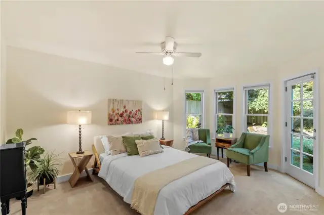 Wake-up in you light filled main-floor primary bedroom with outdoor deck access and ensuite.