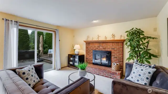 The family room has a real brick gas log fireplace and double sliding glass doors for access to the backyard.
