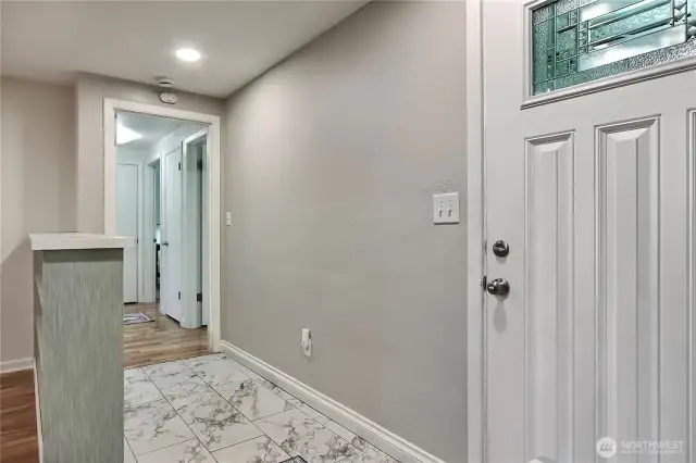 As you enter, you will find lovely tile flooring in the entry, and to your right the hallway to beds and bath.