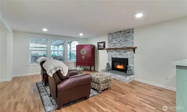 View of the massive living room from entry, LOVE these hardwood floors and fireplace, plus larger windows and LED lighting.