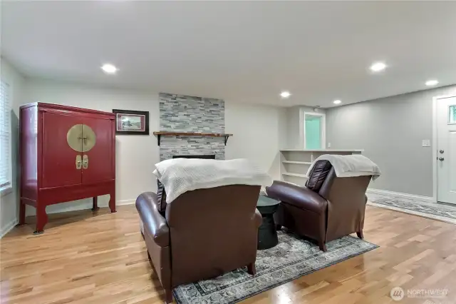 View of the living room toward entry and hall, loving those built-in bookcases.