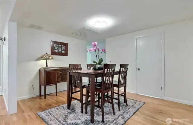 View of dining room from the living room, kitchen is off to your left and the door leads to your powder room.