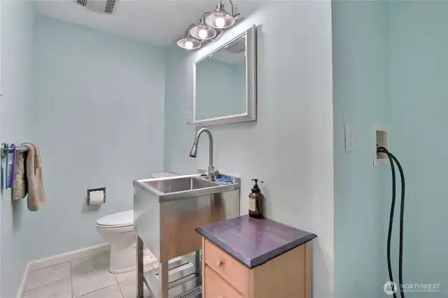 Powder room off of dining room, plumbed for stackable washer/dryer.