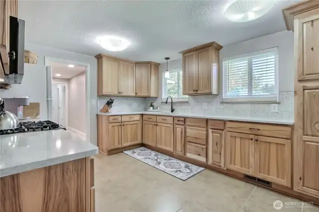 Kitchen view 1, towards entry. Love the gas stove/range, beautiful cabinetry and all the counter space. Lots of room for you and family/friends to prepare amazing meals together.