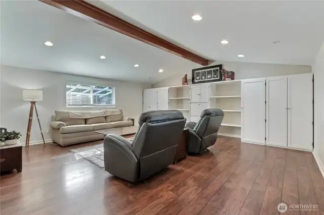 Family room view 1, just a massive space with vaulted ceilings, gorgeous flooring and tremendous built-ins. Love the giant beam as well!