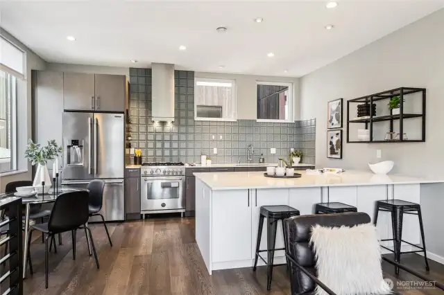 Gas range, stainless steel appliances, breakfast bar seating as well as room for sit-down meals.