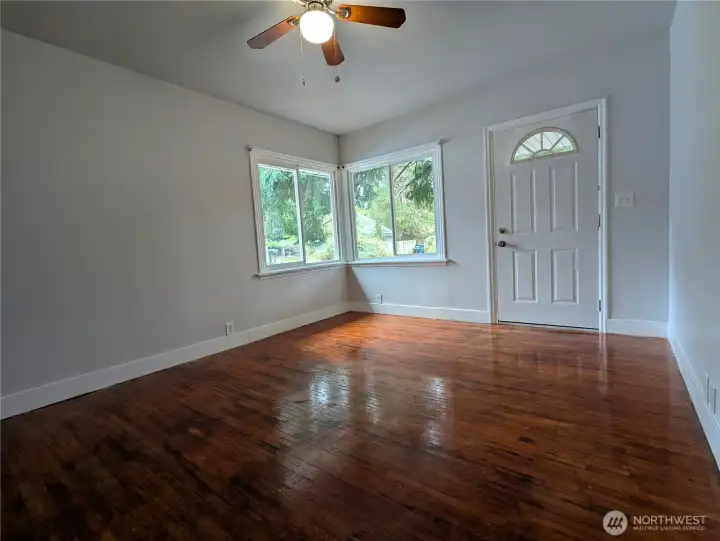 Main entrance into the living room with hardwood floors.