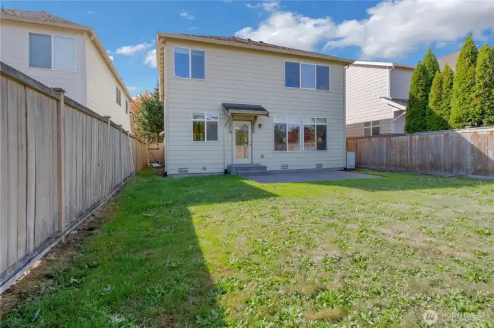 Fully fenced deep back yard with patio.