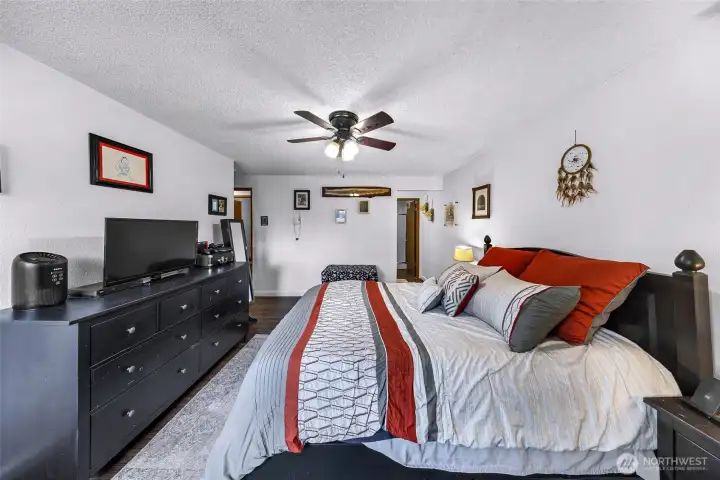 Another view of the primary bedroom and 3/4 bathroom.