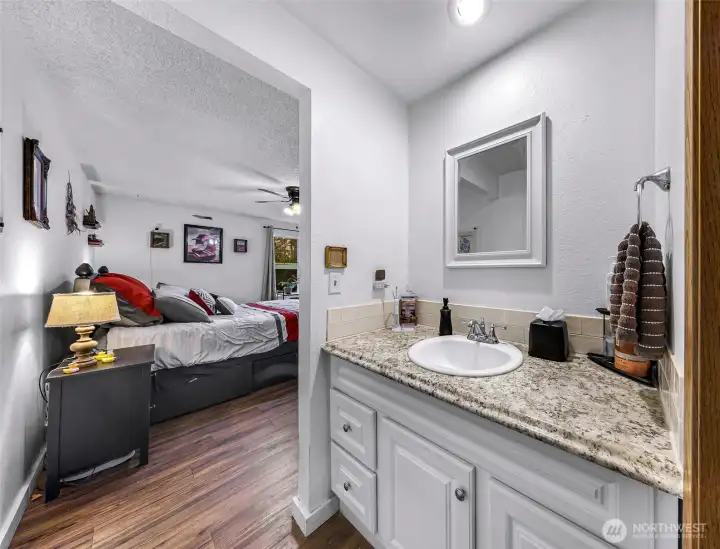 A view of the primary sink and bedroom