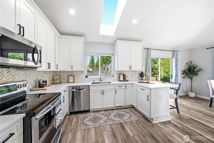 Stunning remodeled kitchen w/ shaker cabinetry & durable quartz countertops.