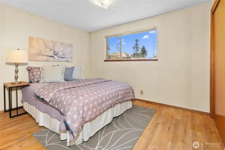 Bedroom #2, on upper level with window over backyard.