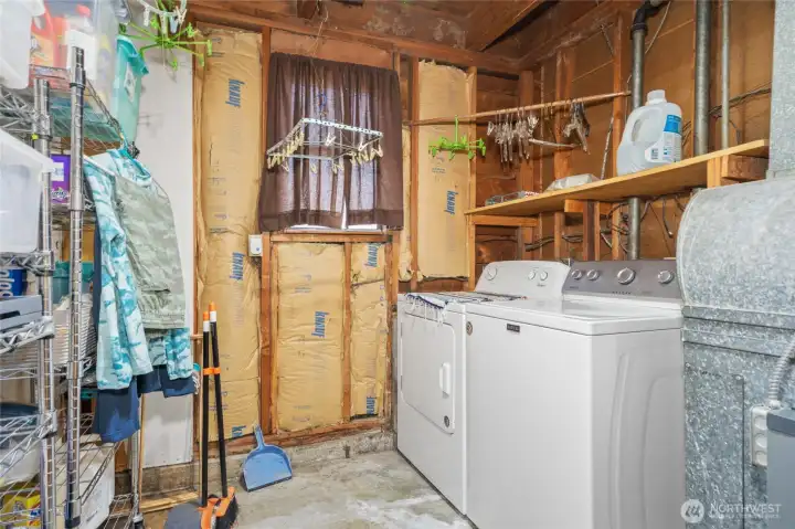 Partially finished, lower-level laundry room provides a view into quality construction.