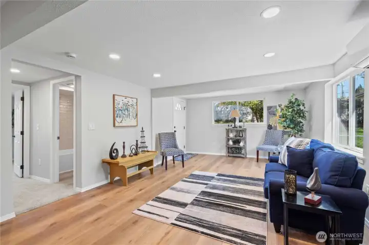Living Room showing Full Hall Bath Entry. Door to Far Left leads into Primary Bedroom. Door in middle leads to covered back patio.