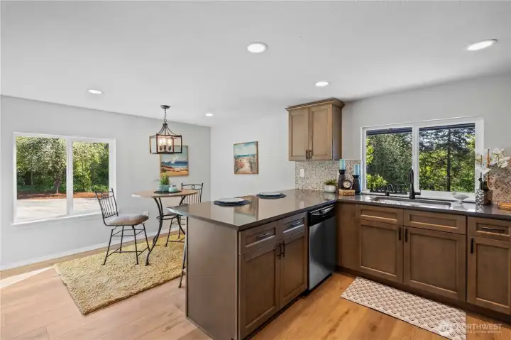 Kitchen w/New Cabinets w/Crown & Pulls. Quartz Counters, Stainless Steel Sink and Appliances.