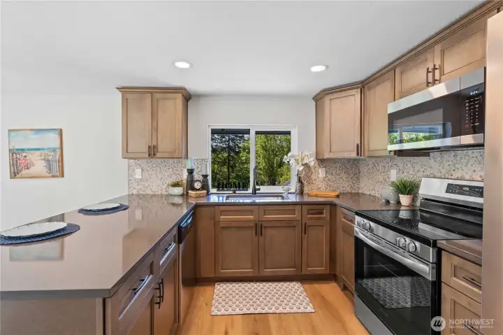 Custom Tile Backsplash, Recessed Lighting and Breakfast Bar.