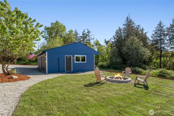 Side of the Garage showing the new door and window. Additional yard with firepit is perfect for evenings spent outside!
