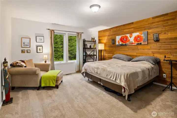 Main floor bedroom with warm wood accent walls.