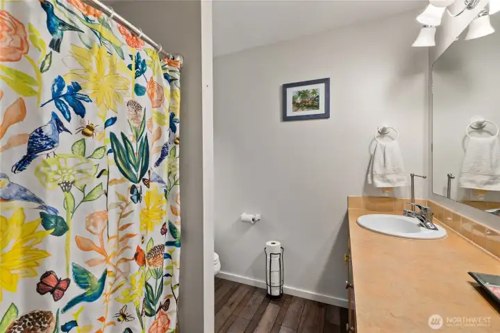 Bright full bathroom with clean finishes and natural light.