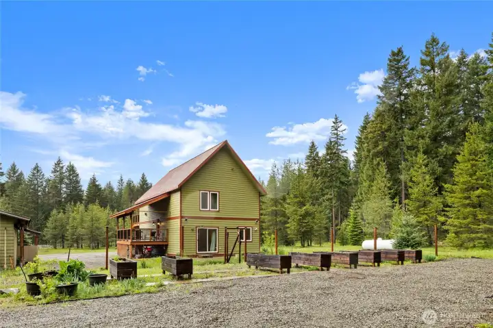 Nearly 2.7 acres with open space and mature evergreens.