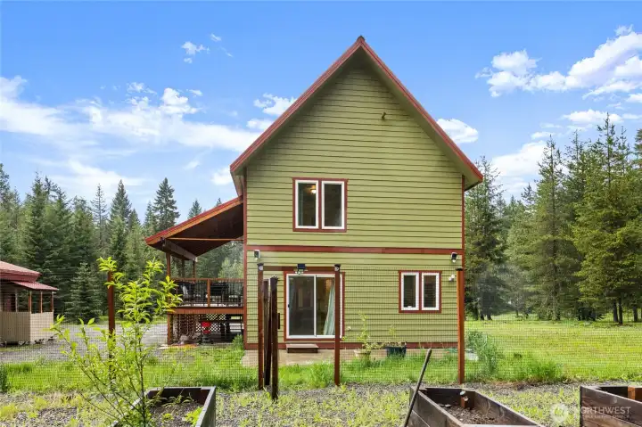 Views of the back of the home surrounded by year-round natural beauty.
