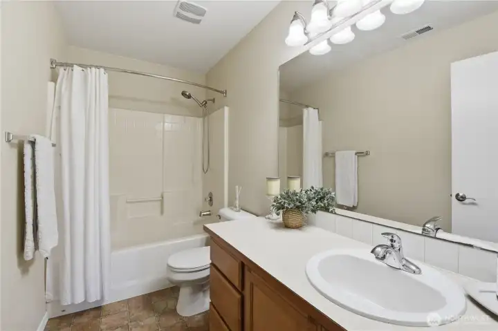The main bath has an oversized vanity for excellent storage.