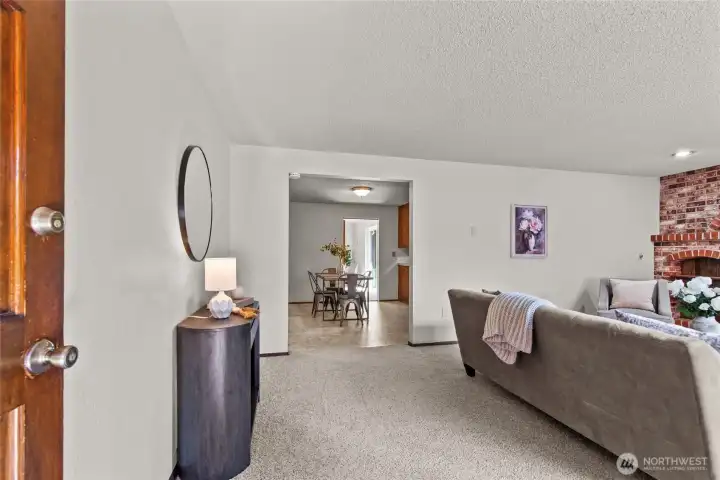 Enter the front door into the large and welcoming living room with walkway to the kitchen and dining room Enter the front door into the large and welcoming living room with walkway to the kitchen and dining room