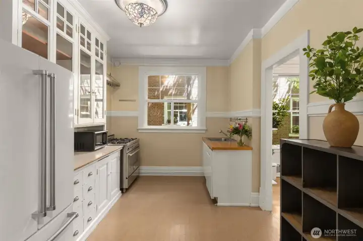 Spacious kitchen w/ glass upper cabinets & stained glass light shade. Spacious kitchen w/ glass upper cabinets & stained glass light shade.
