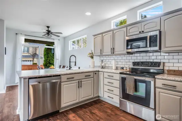 Kitchen seamlessly flows into the bright breakfast nook and extends to the covered outdoor patio, creating the perfect setup for indoor-outdoor dining and entertaining.