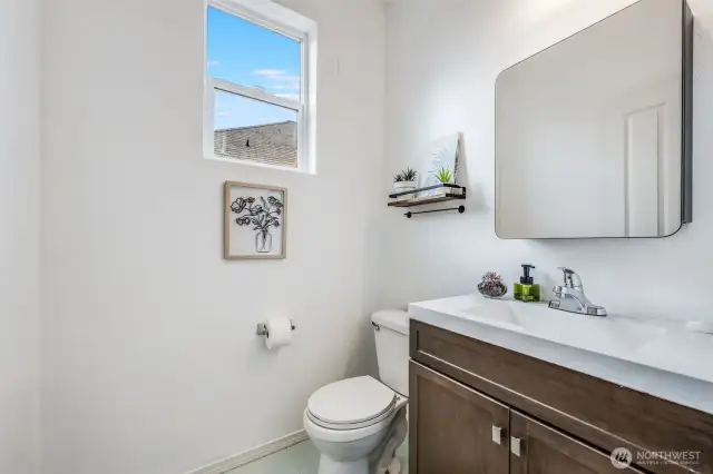 Conveniently located on the main floor, this stylish half-bath offers a modern vanity, natural light, and a welcoming space for guests.