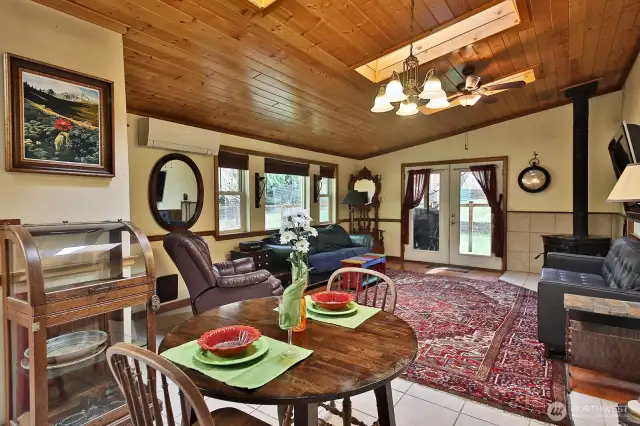 Open floor plan. Living room has wood burning fireplace, Skylights T&G ceilings and French doors out deck for entertaining. Ductless heating and air.