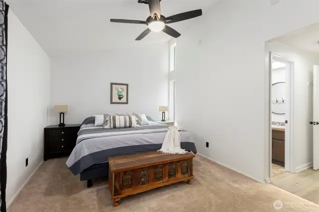 Vaulted ceilings and custom window make this room feel huge