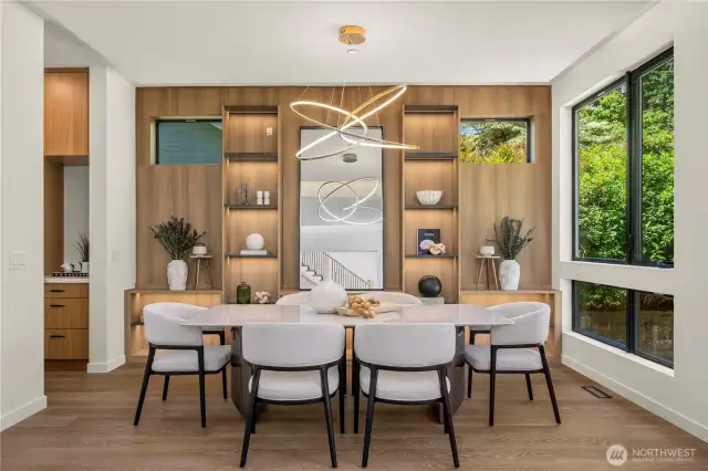 A beautifully designed formal dining room includes a lighted built-in niche, blending practicality with refined architectural detail for an elevated dining experience.