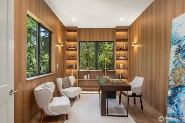 The dedicated home office features a custom built-in shelf with integrated lighting, offering both functionality and sophistication—perfect for focused work or creative pursuits.