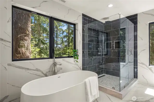 The master bath is a spa-like sanctuary featuring a luxurious oversized walk-in shower, dual vanities, and premium finishes throughout.