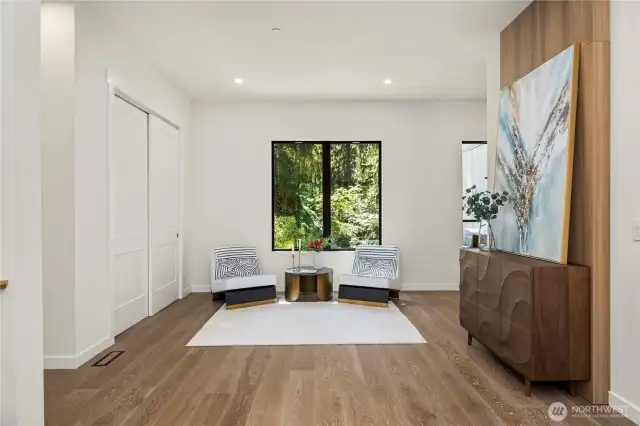 An inviting entry sitting area blends comfort with design, creating a graceful transition into the heart of the home.