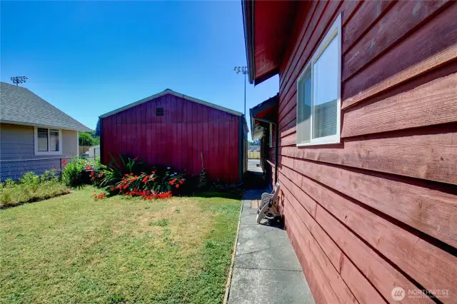 Fully fenced and gated side yard leads to garage & carport