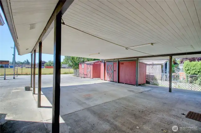 Attached 4 car carport plus two storage sheds - room for all your toys, tools, or