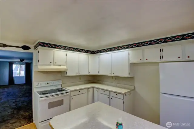 Big, bright kitchen with white cabinets. All appliances stay!