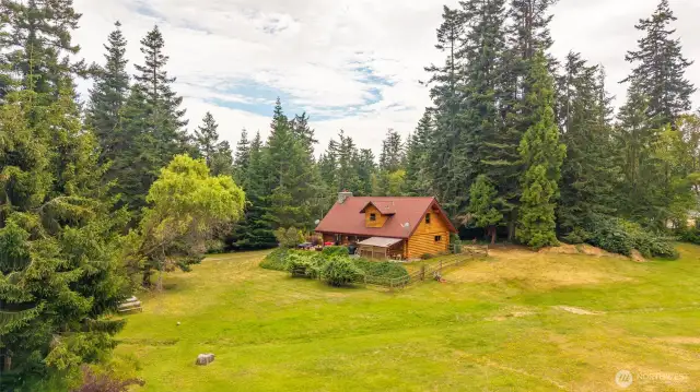 Open pastures, a small orchard-like area with fruit trees, a greenhouse, and space to roam all on this 5-acre property.