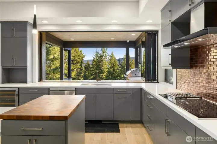 Kitchen area with butcher block counter and Nanawall windows