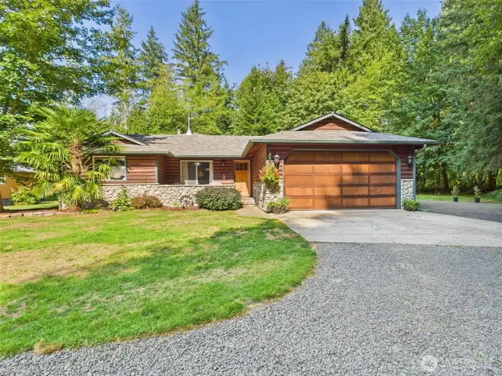 Front of home with large RV area to the side.