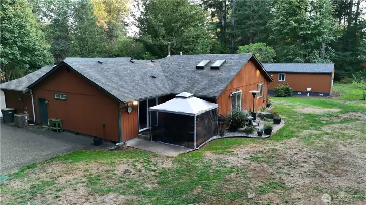 Back of home. Great patio area right off the Primary bedroom and dining area.