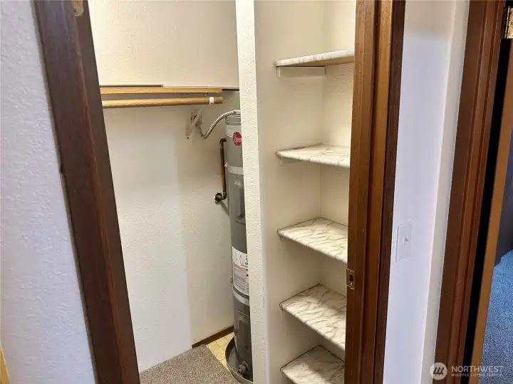 Hallway storage closet, water heater located here