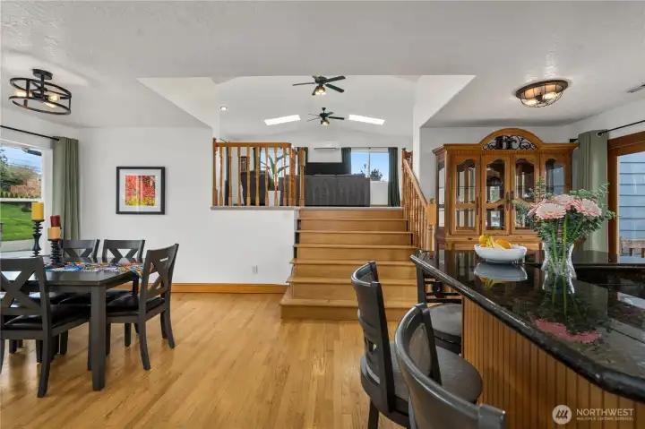 Just look at this Open Kitchen/Dining Area! Earth tones and warm-toned, hardwood flooring create a very comfortable atmosphere in this spacious home. The Natural Lighting, Numerous Windows and Very Spacious Rooms add to its comfort and charm. Step up to that amazing Great Room/Family Room…….