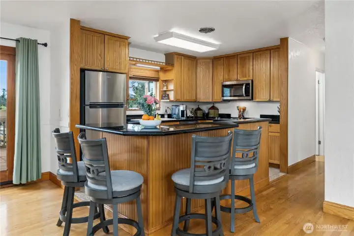 …..this Beautiful Granite Island Breakfast Bar, great for gathering around during meal prep, and the French Doors provide a quick path to the 3-Level Deck for outdoor grilling and entertaining ….so close to the kitchen.