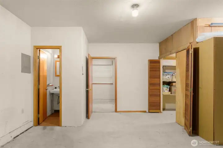 Garage 1/2 bath on left, office/craft room in middle and large storage room to the right.