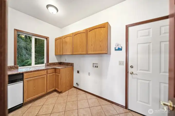 Off the Kitchen...Laundry Room has cabinetry, trash compactor, and a closet.
